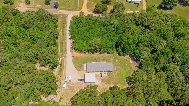 an aerial view of a house with a yard and garden