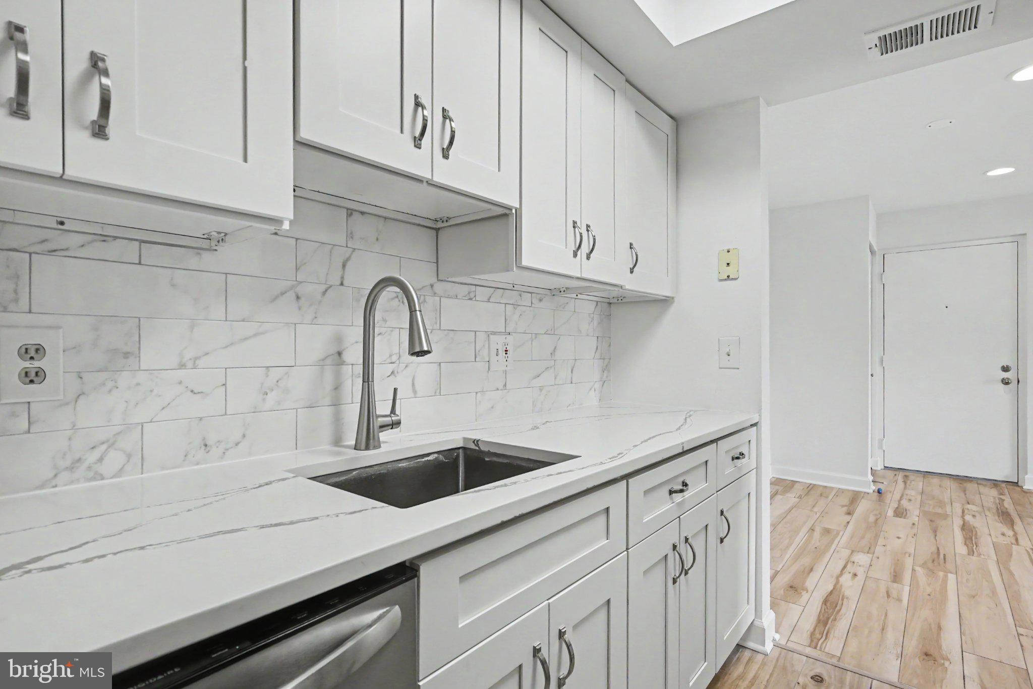 14800 Rydell Road, Unit 201 Centreville, VA 20121 - Photo 12 of 28 Sleek modern kitchen with marble accents.