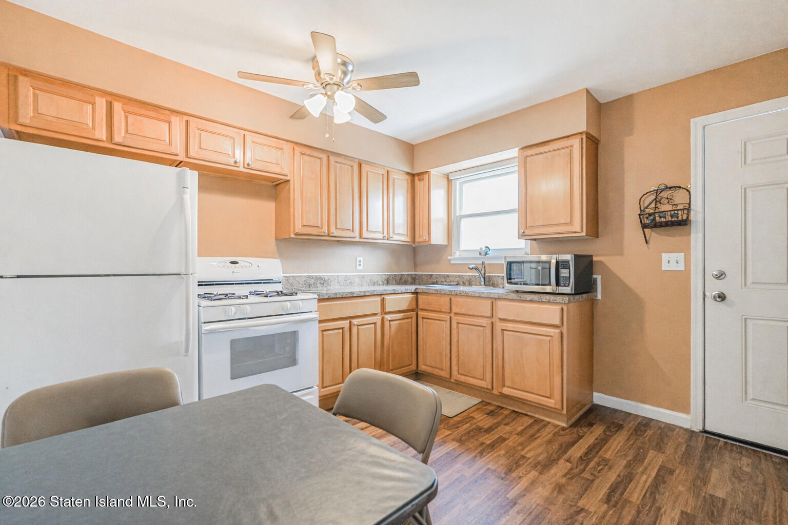 76 Berry Avenue Staten Island, NY 10312 - Photo 26 of 42 a kitchen with granite countertop a stove a sink dishwasher and a refrigerator with wooden floor