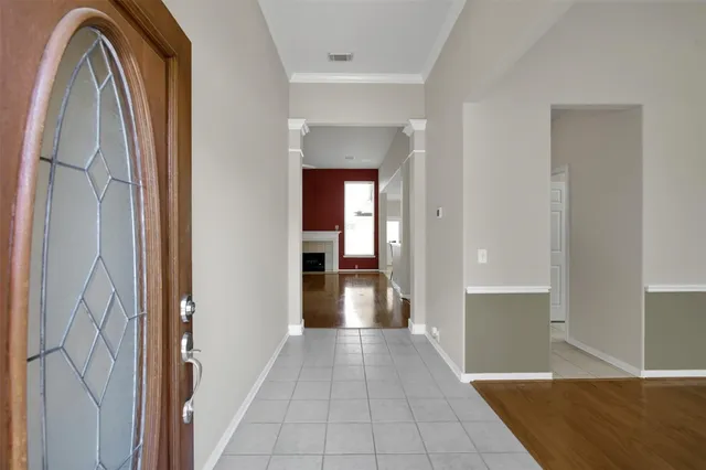 a view of a hallway with wooden shelves