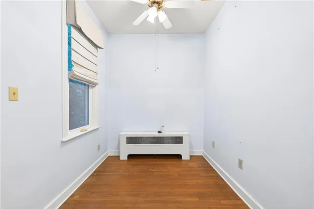 a view of a hallway with a window and a chandelier