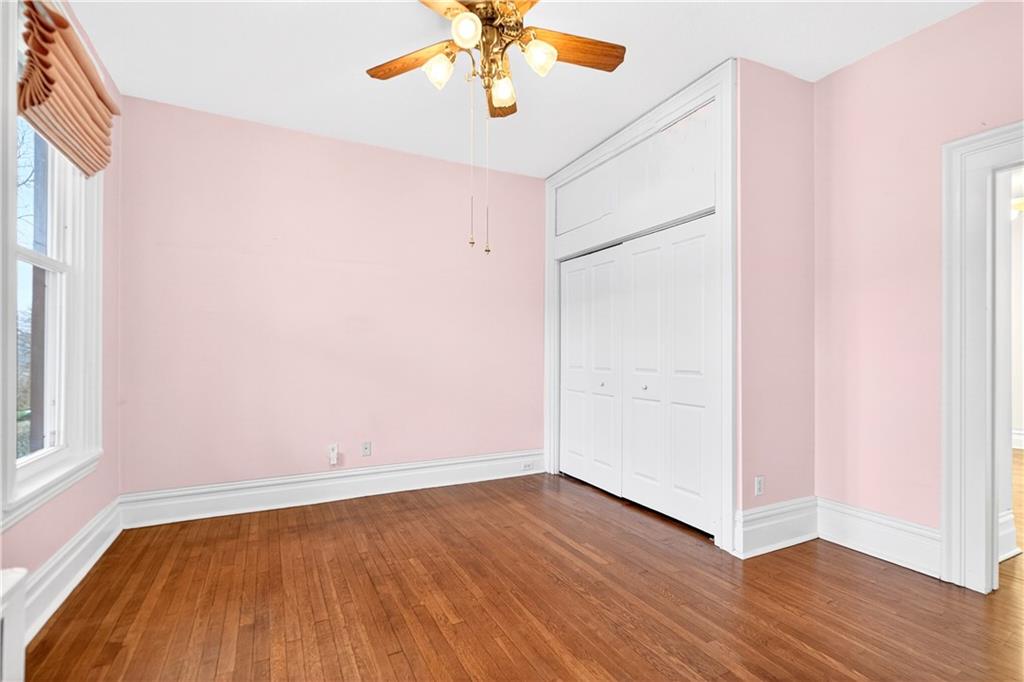 136 1/2 Chess Street Monongahela, PA 15063 - Photo 19 of 50 an empty room with wooden floor chandelier fan and windows