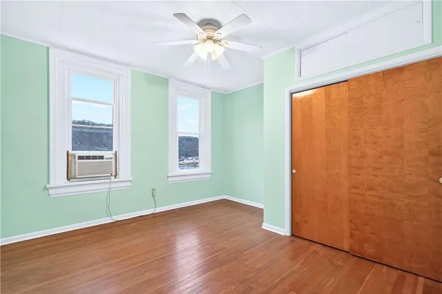 wooden floor in an empty room with a window