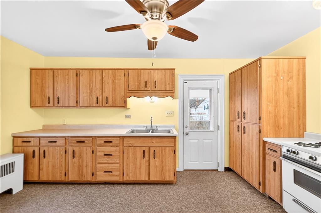136 1/2 Chess Street Monongahela, PA 15063 - Photo 33 of 50 a kitchen with a stove top oven cabinets and a refrigerator