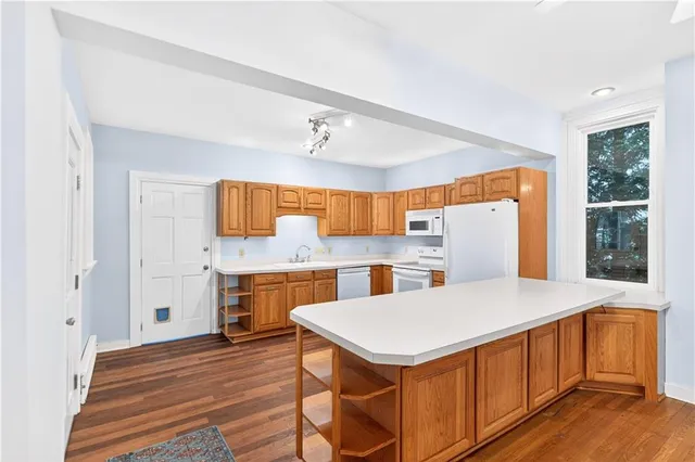 a kitchen with a table chairs sink and cabinets