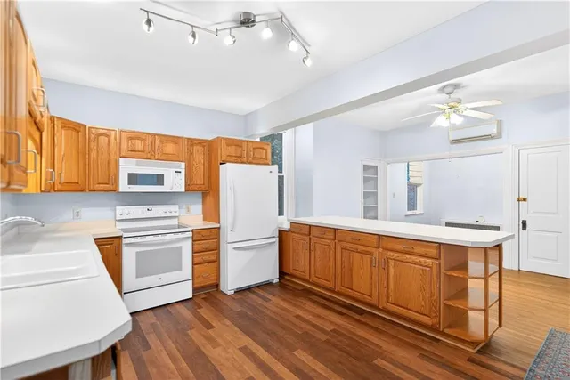 a kitchen with stainless steel appliances a stove a sink dishwasher and a refrigerator