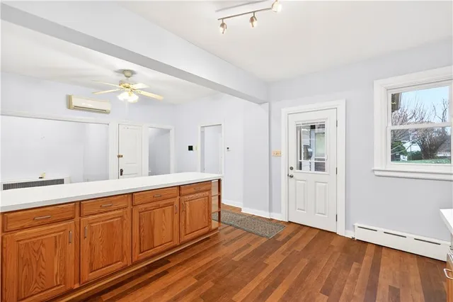 a spacious bathroom with stainless steel appliances a sink and a mirror