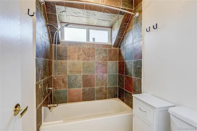 a bathroom with a bathtub and a shower