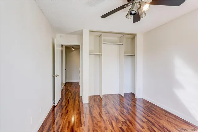 a view of hallway with wooden floor and chandelier