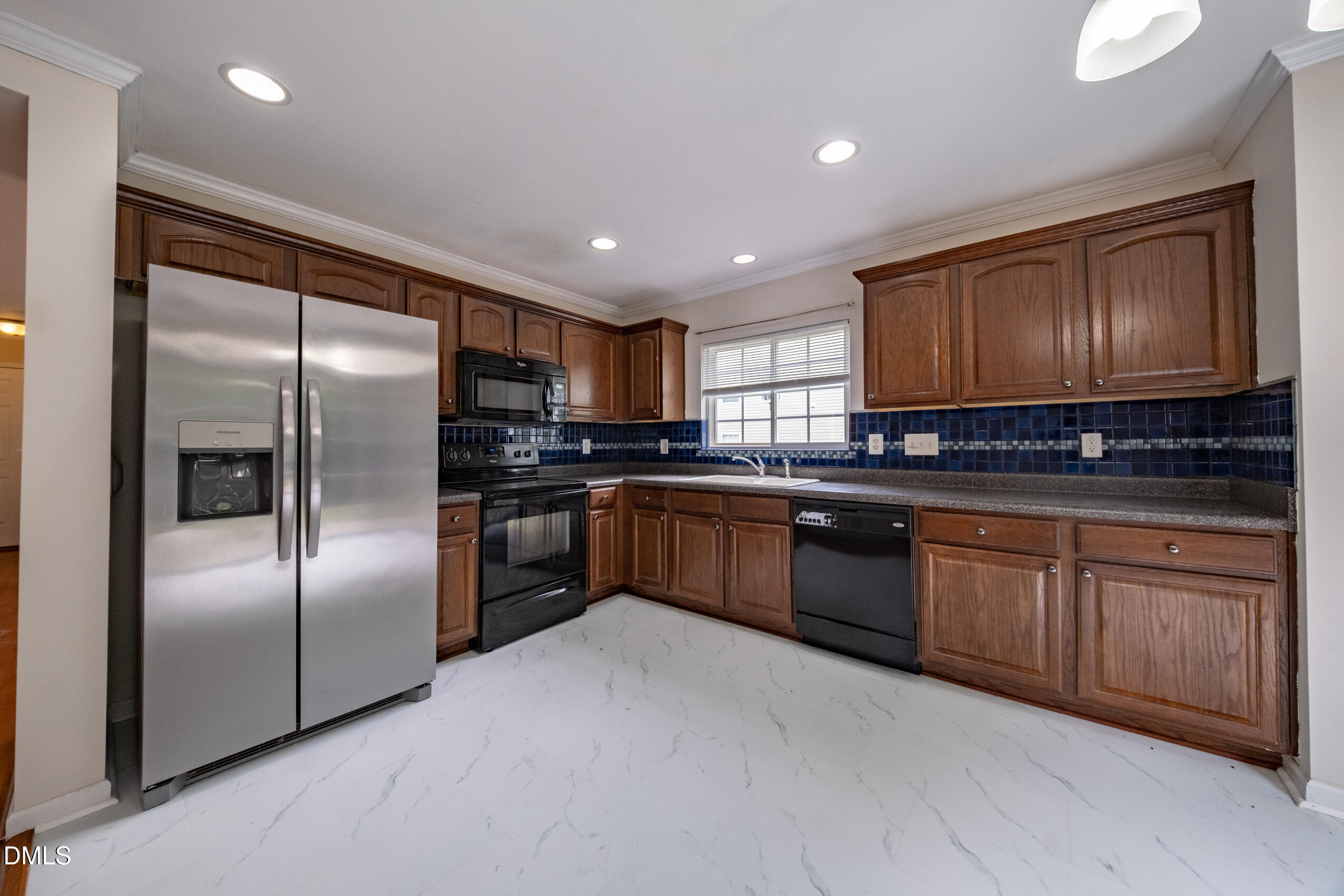 719 Obsidian Way Durham, NC 27703 - Photo 14 of 41 a kitchen with granite countertop stainless steel appliances and refrigerator