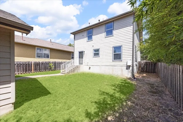 a view of a house with backyard and porch