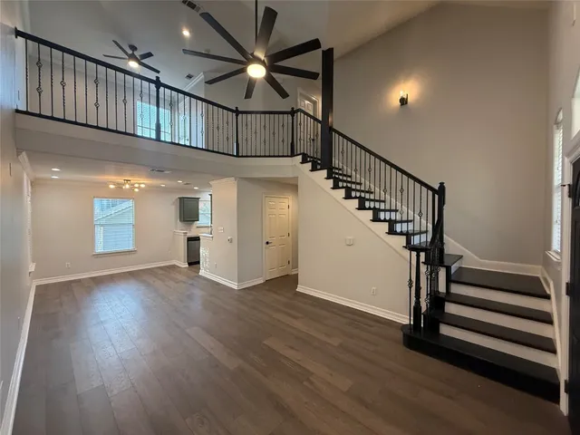 a view of staircase with wooden floor and a window
