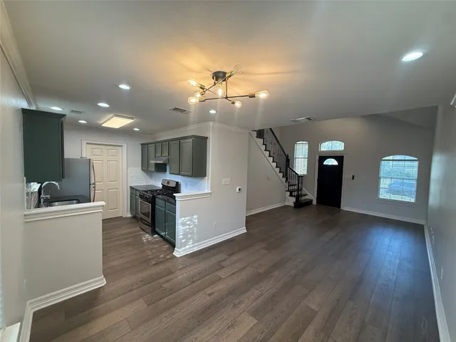 a view of a living room and kitchen with furniture a flat screen tv