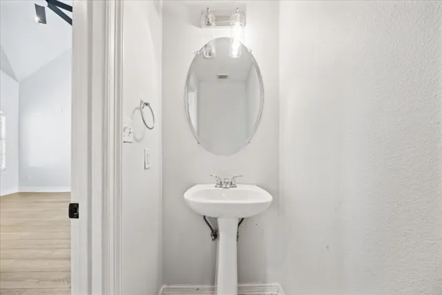 a bathroom with a sink a mirror and a mirror