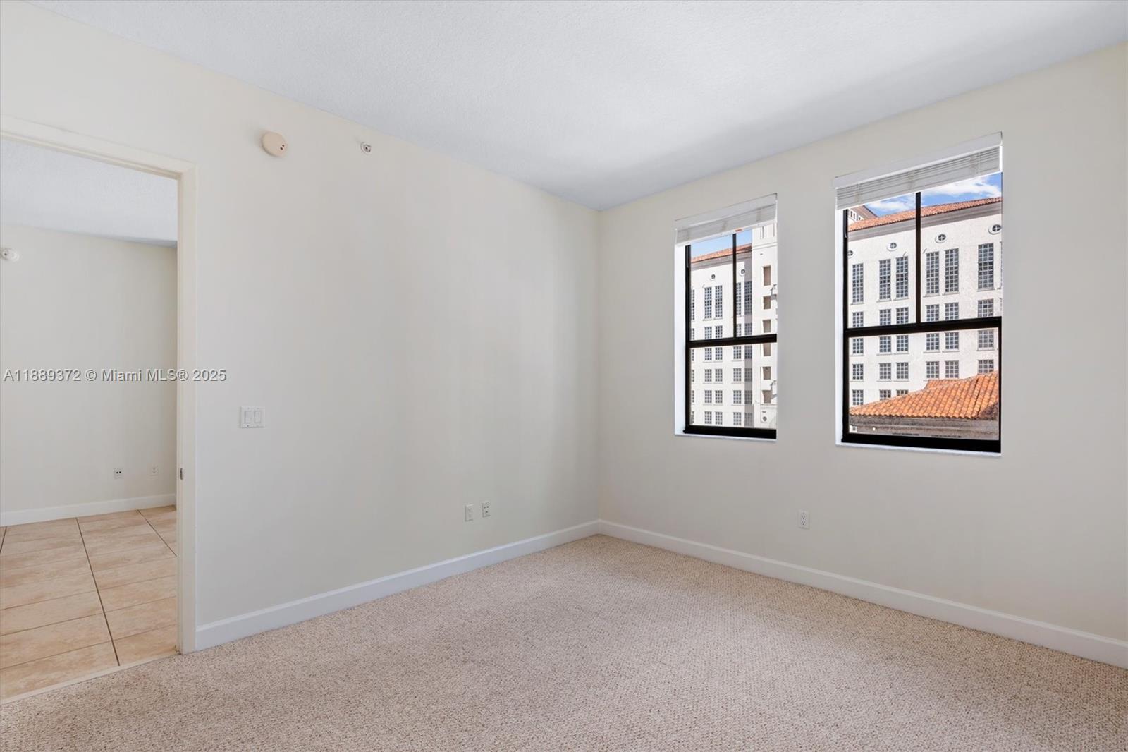 55 Merrick Way, Unit 814 Coral Gables, FL 33134 - Photo 12 of 39 an empty room with windows