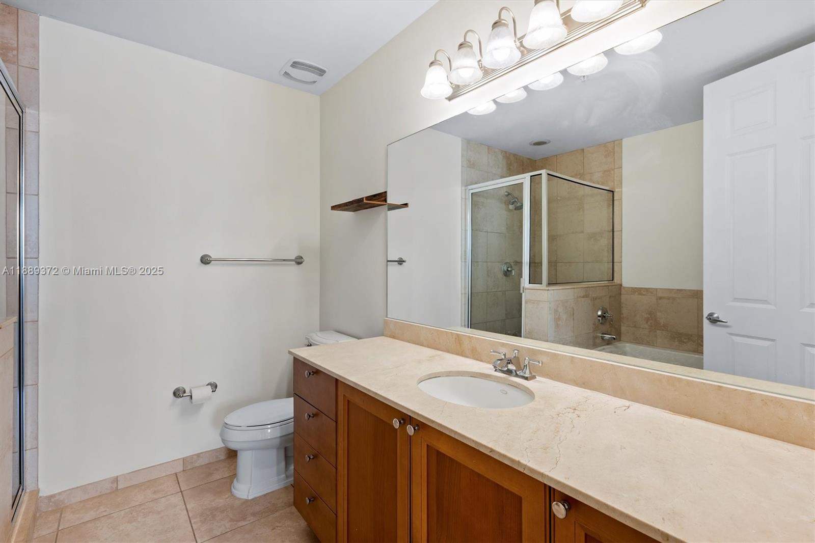 55 Merrick Way, Unit 814 Coral Gables, FL 33134 - Photo 14 of 39 a bathroom with a granite countertop sink a toilet and shower
