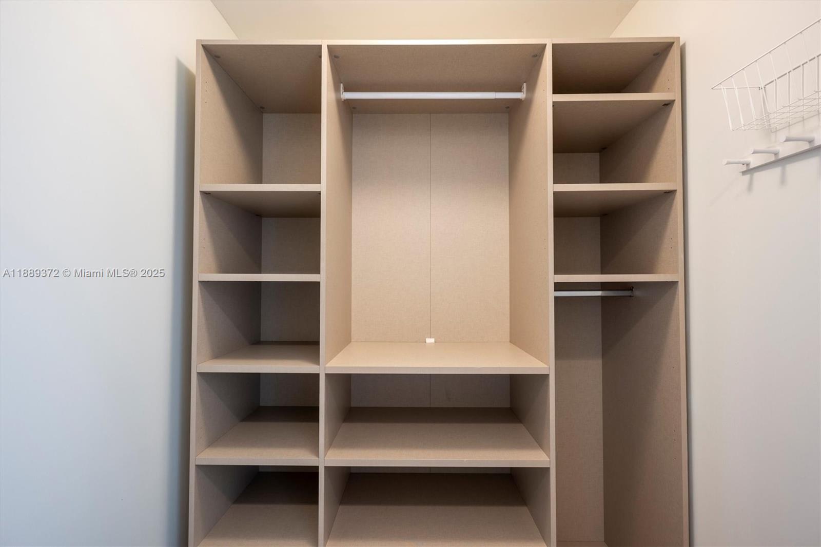 55 Merrick Way, Unit 814 Coral Gables, FL 33134 - Photo 15 of 39 a view of walk in closet with empty racks