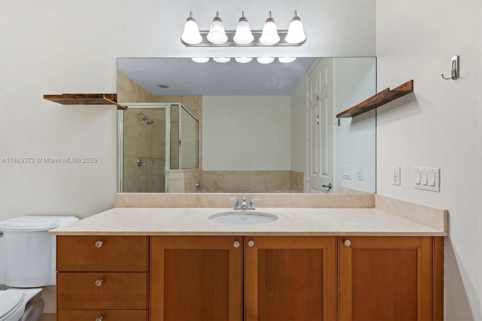 55 Merrick Way, Unit 814 Coral Gables, FL 33134 - Photo 17 of 39 a bathroom with a sink and a mirror