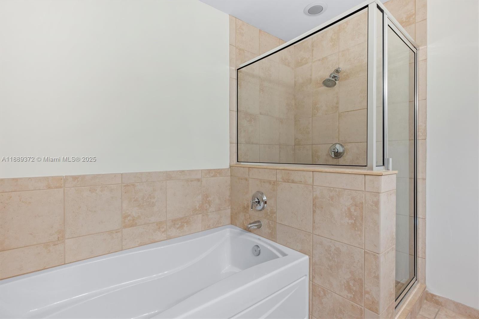 55 Merrick Way, Unit 814 Coral Gables, FL 33134 - Photo 18 of 39 a bathroom with a bathtub and shower
