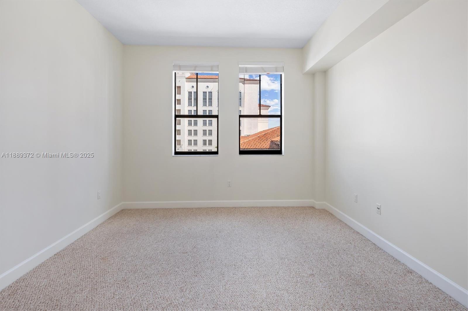 55 Merrick Way, Unit 814 Coral Gables, FL 33134 - Photo 23 of 39 an empty room with windows and closet