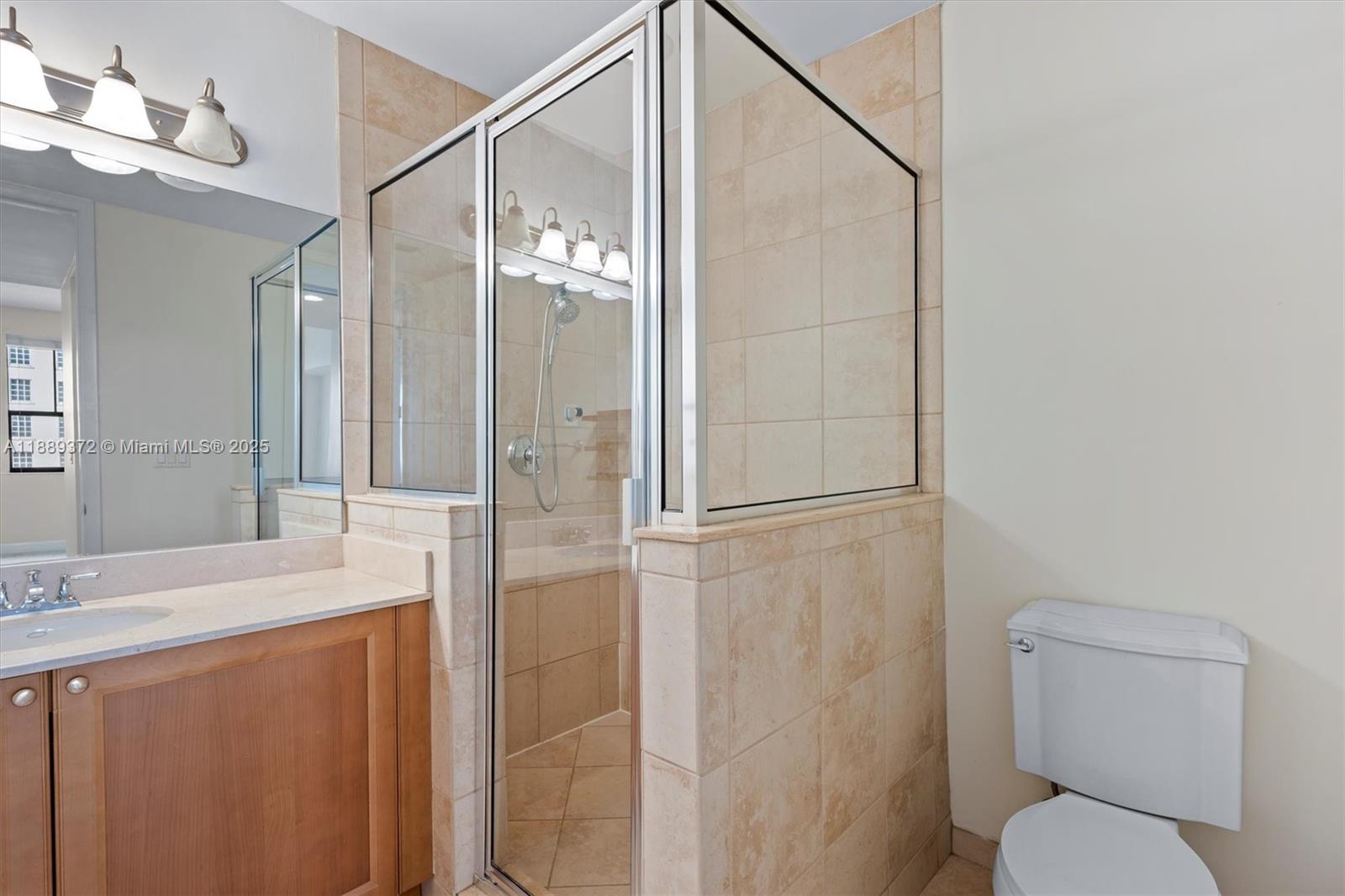 55 Merrick Way, Unit 814 Coral Gables, FL 33134 - Photo 26 of 39 a bathroom with a granite countertop sink toilet and shower