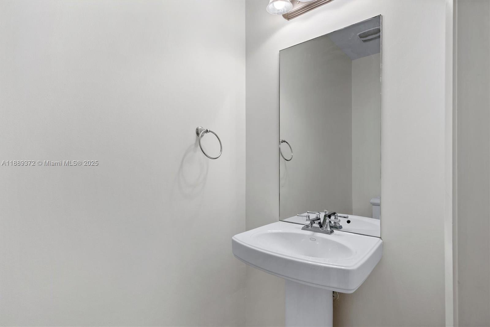 55 Merrick Way, Unit 814 Coral Gables, FL 33134 - Photo 29 of 39 a bathroom with a sink and a mirror