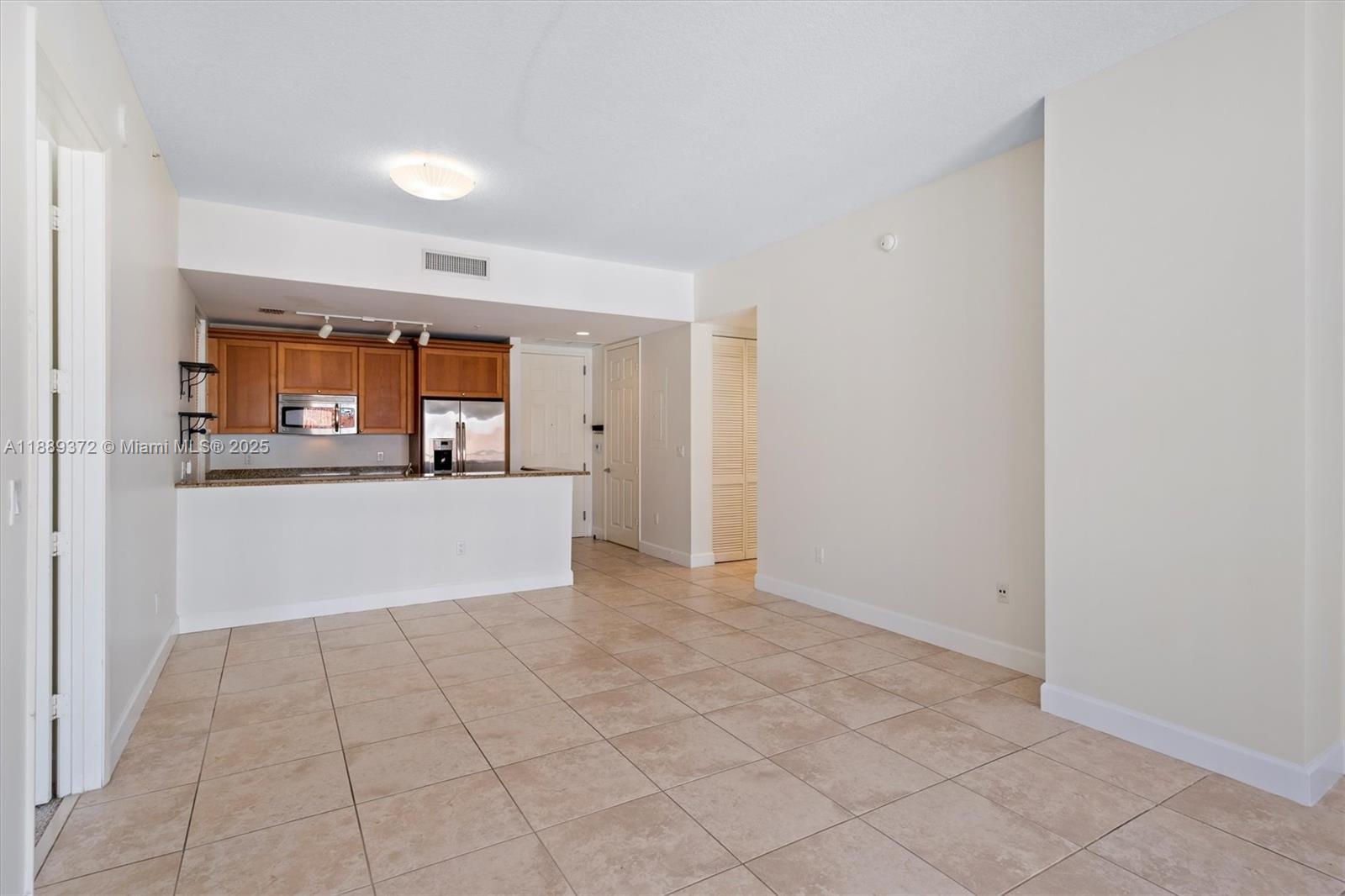 55 Merrick Way, Unit 814 Coral Gables, FL 33134 - Photo 30 of 39 a view of a big room with wooden floor and a window