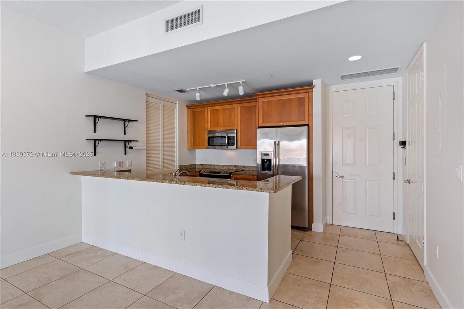 55 Merrick Way, Unit 814 Coral Gables, FL 33134 - Photo 31 of 39 a kitchen with stainless steel appliances a refrigerator and a stove top oven