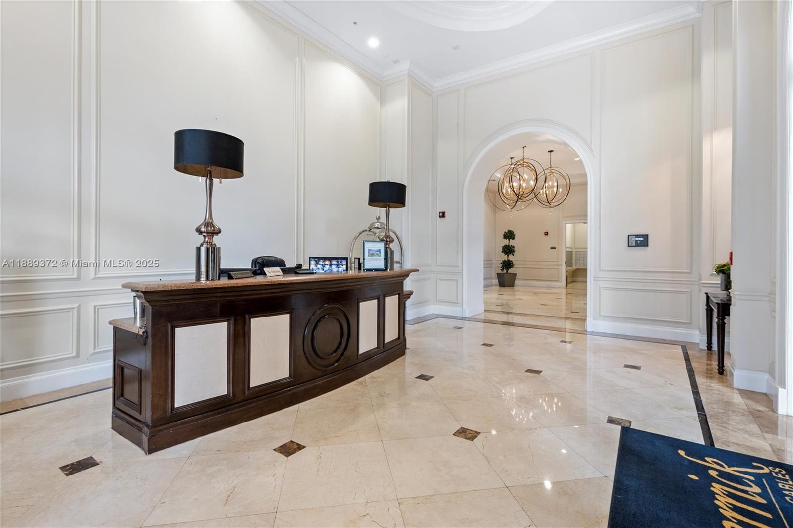 55 Merrick Way, Unit 814 Coral Gables, FL 33134 - Photo 36 of 39 a kitchen with stainless steel appliances a stove a table and a chandelier
