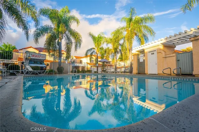 a swimming pool with outdoor seating and water view