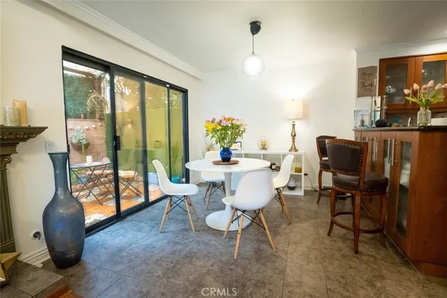 a dining room with furniture a chandelier and wooden floor