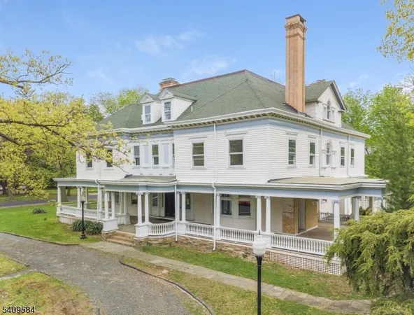 a front view of a house with a garden and plants