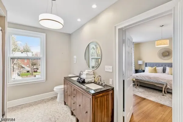 a living room with furniture a clock and a window