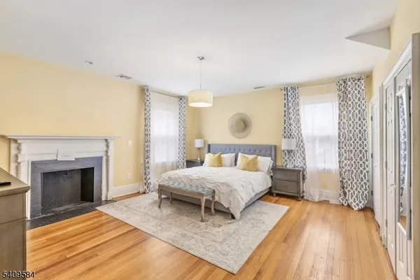 a living room with a bed and a fireplace
