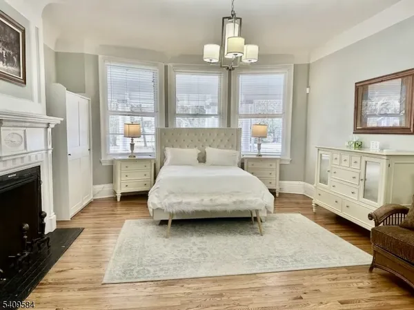 a spacious bedroom with a bed and a dresser