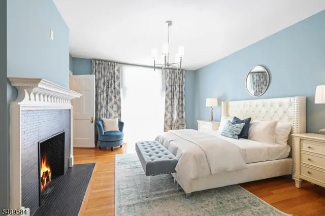 a bedroom with a bed and a fireplace