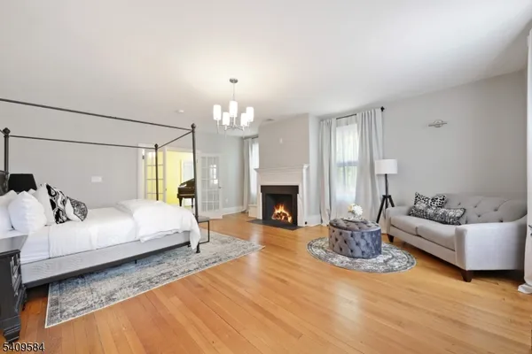 a spacious bedroom with a bed and a fireplace