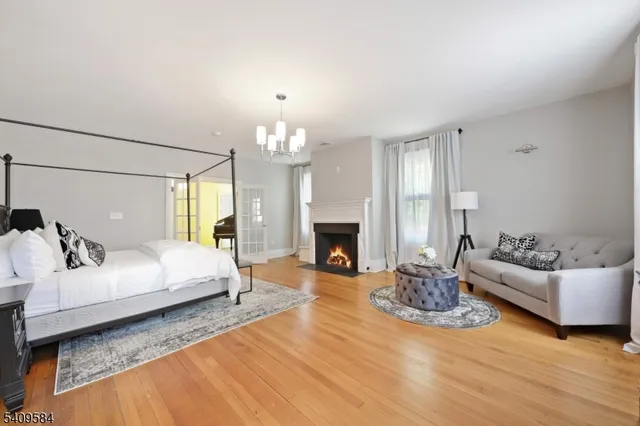 a spacious bedroom with a bed and a fireplace