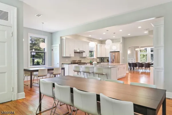 a dining room with kitchen island a stove a table and chairs