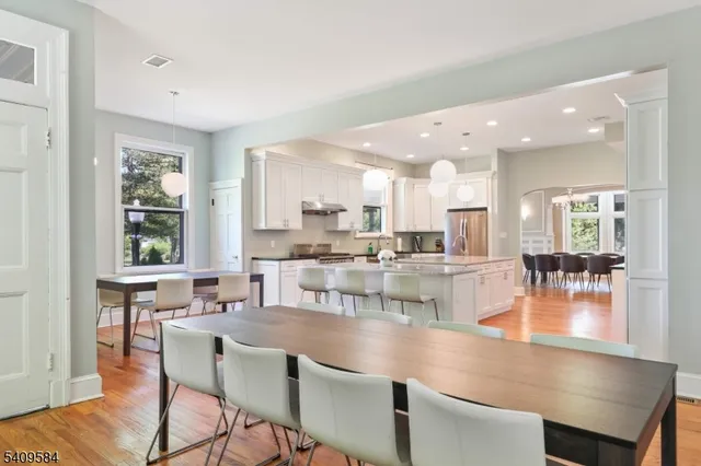 a dining room with kitchen island a stove a table and chairs