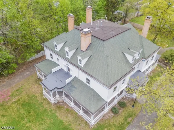 an aerial view of a house with swimming pool and big yard