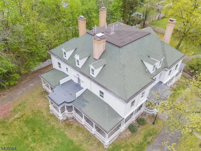 an aerial view of a house with swimming pool and big yard