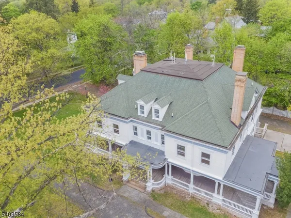 an aerial view of a house with a yard
