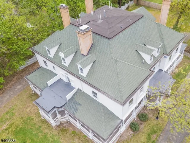an aerial view of house with backyard