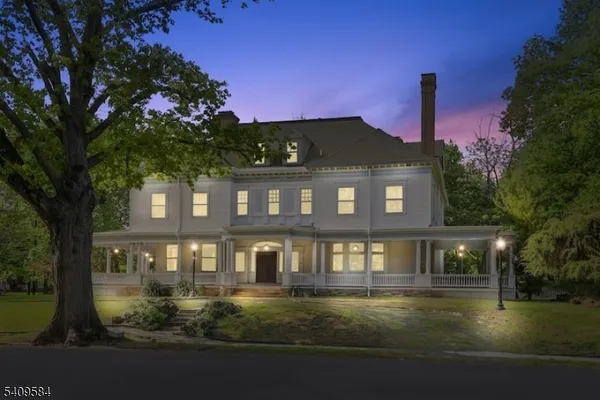 a front view of a house with yard swimming pool and outdoor seating