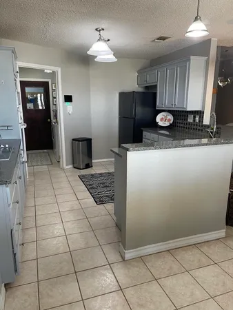 a open kitchen with cabinets and stainless steel appliances