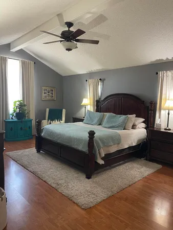 a bedroom with a bed lamp and window