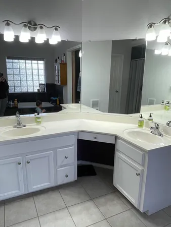a bathroom with a sink vanity and mirror