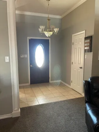 a view of a livingroom with a chandelier fan