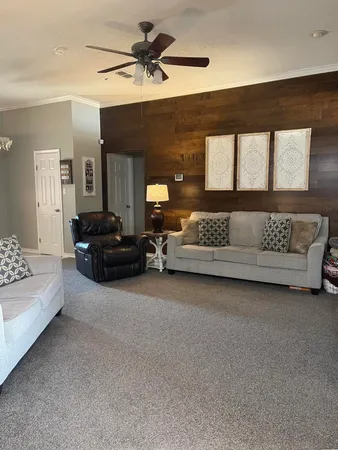 a living room with furniture and a large window